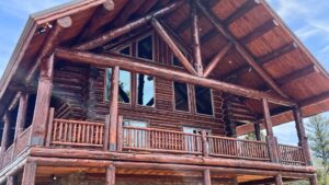 a beautiful log cabin with shades of red in the wood