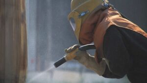 a Baldwin Restoration tech repairing a log home